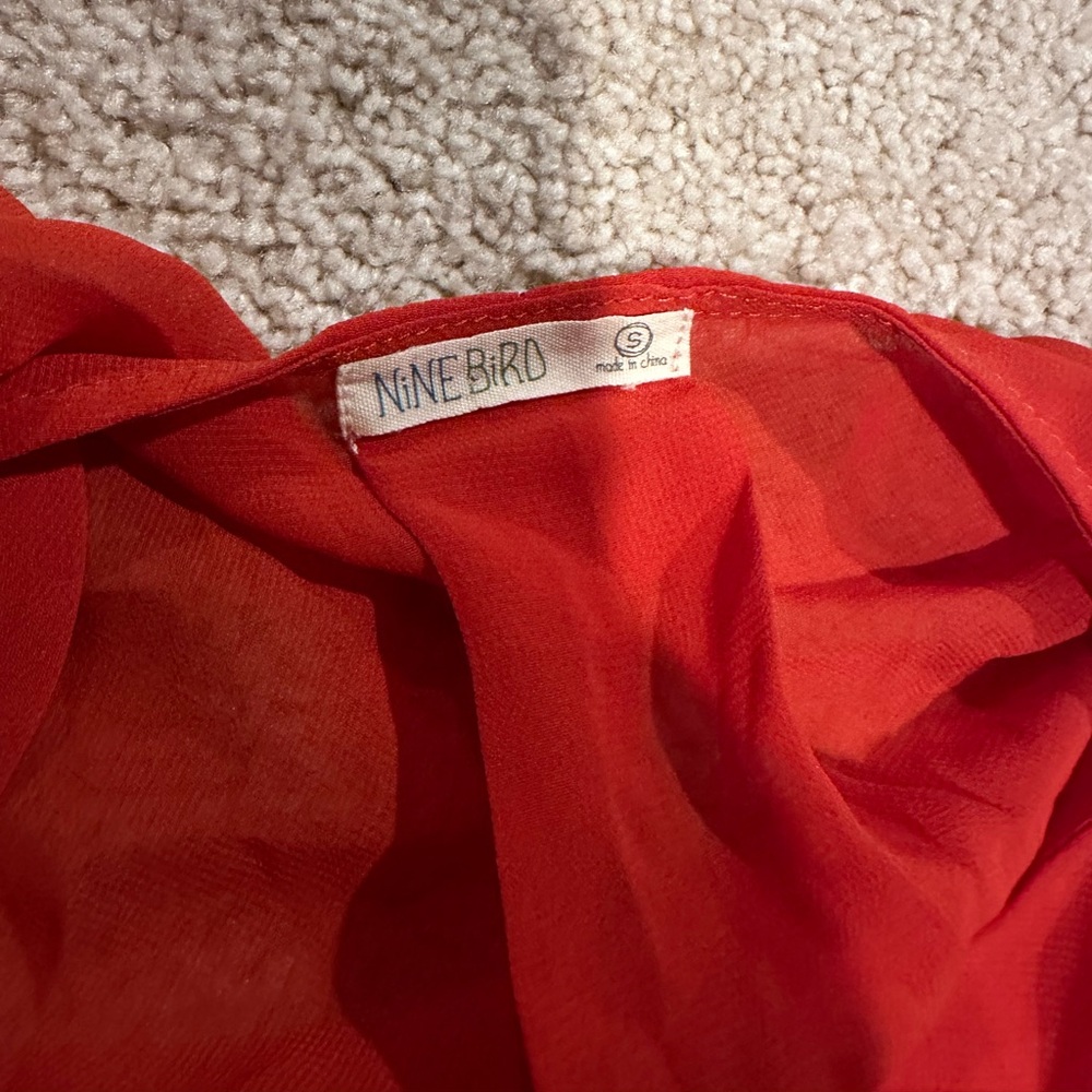 Reddish orange jacket top